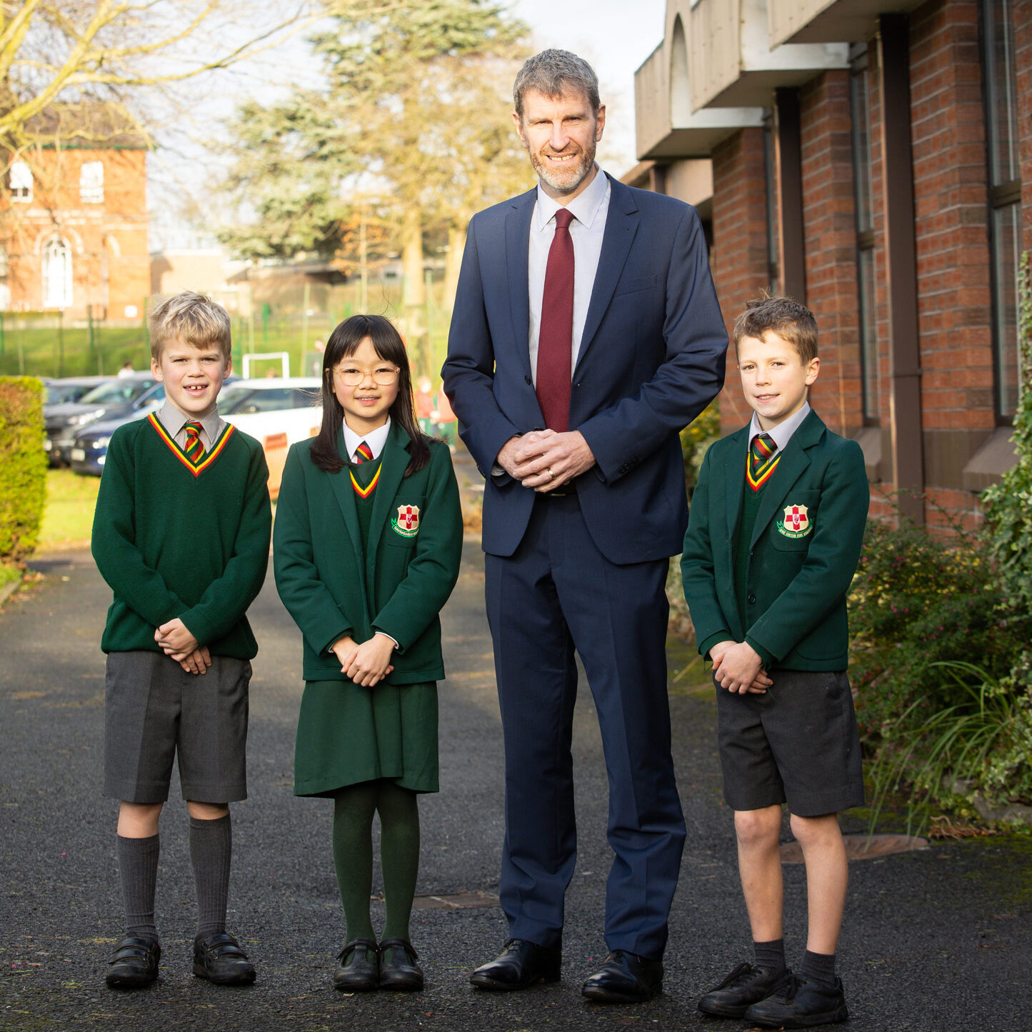 Principal and students posing for a photo