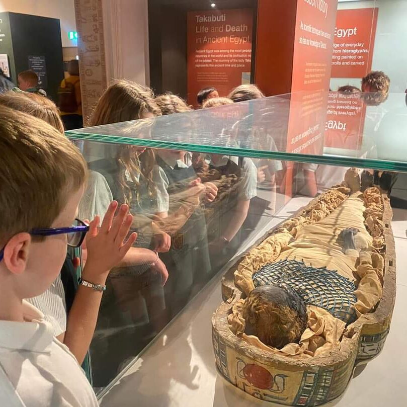 Students looking at an Egyptian mummy
