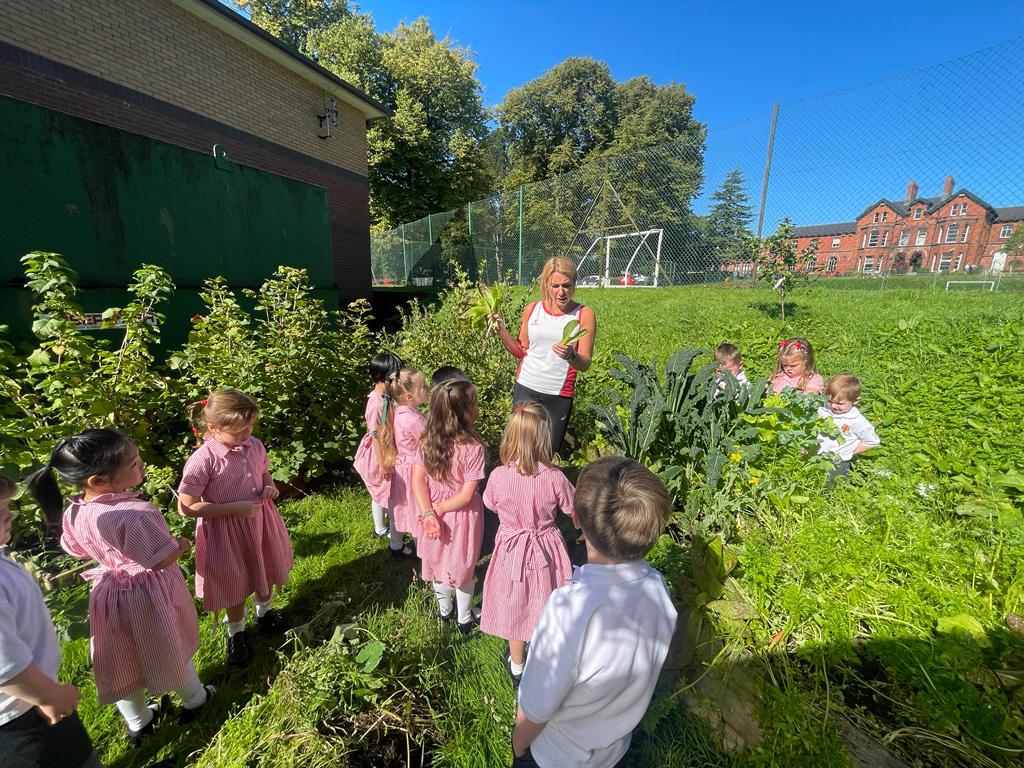 Teacher talking to students in grass