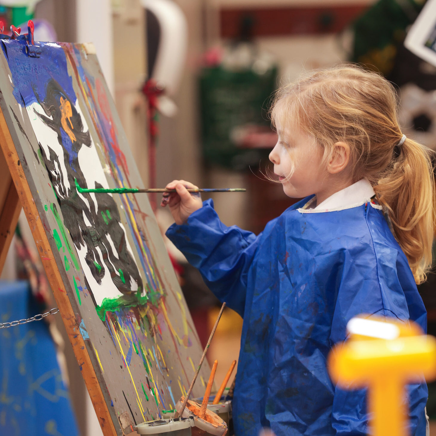 Student painting on an easel