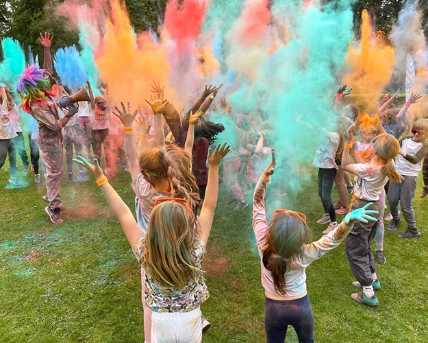 Students playing with coloured chalk/powder