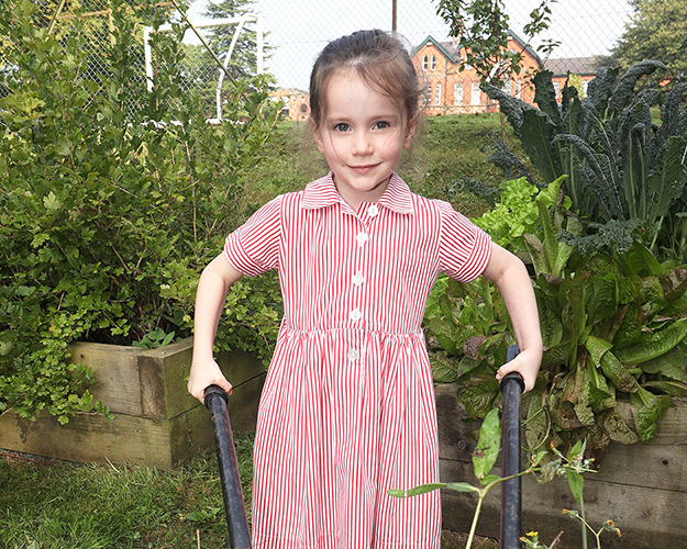 Student holding a wheel barrow