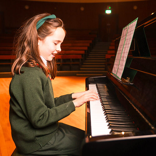 Student playing piano